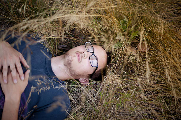 Young man laying is grass. stock photo