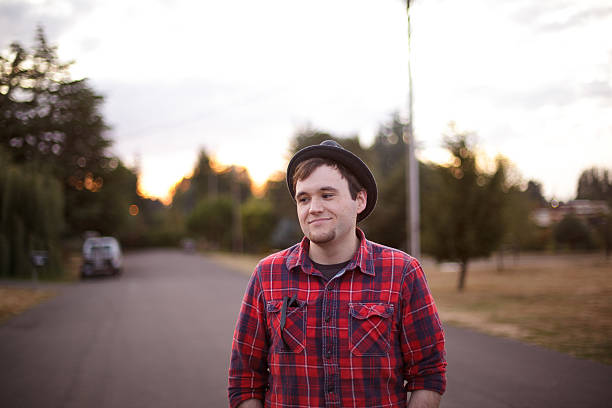 Young man wearing flannel at sunset stock photo