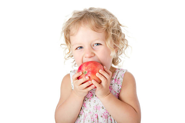 Baby Girl with apple stock photo