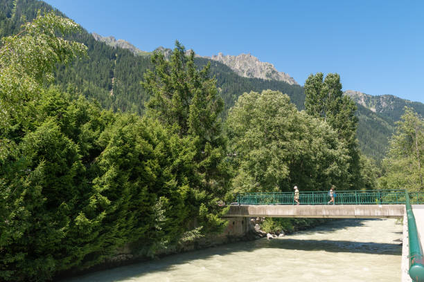Chamonix, Haute Savoie, Auvergne Rhone Alpes, France - 07 27 2023: The Arve River runs through the center of the alpine city at the foot of the Mont Blanc massif.