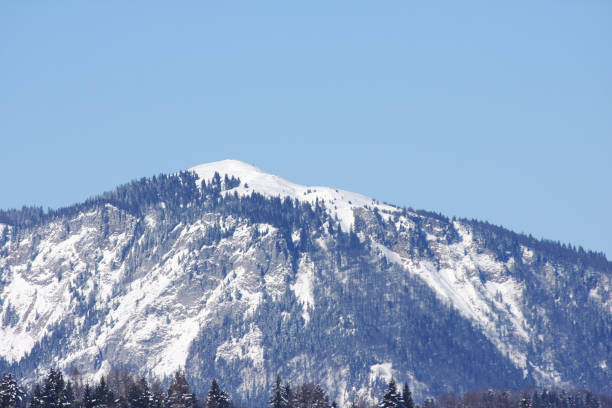 Snowy mountain Blegos above the forests and hills