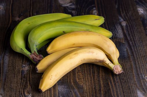 Bunch of fresh ripe organic bananas isolated on white background. Predominant colors are yellow and white. High resolution 42Mp studio digital capture taken with Sony A7rII and Sony FE 90mm f2.8 macro G OSS lens