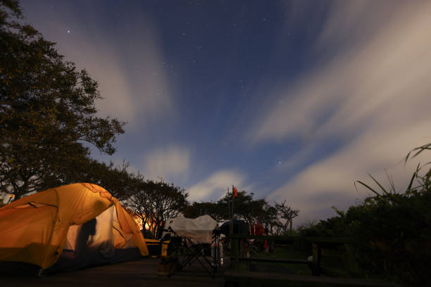 Motorbike camping in the tranquil mountains at night and sleeping in a tent