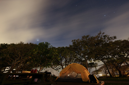 Motorbike camping in the tranquil mountains at night and sleeping in a tent