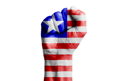 Man hand fist of LIBERIA flag painted. Close-up
