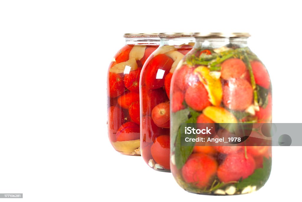 Pomodori rossi in un barattolo di vetro - Foto stock royalty-free di Aceto