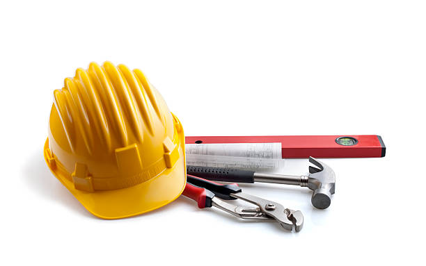 Construction life with yellow hard hat and pile of tools stock photo