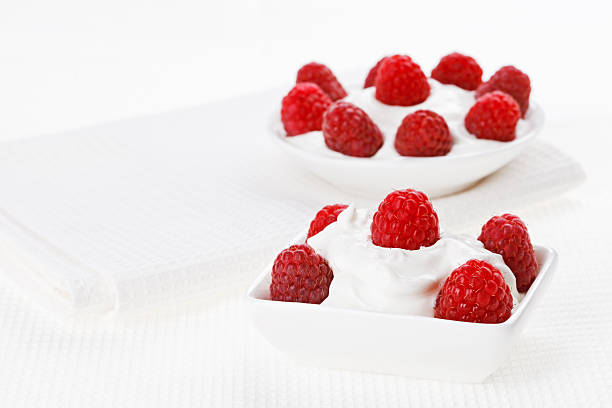 istock Still life with raspberry sour cream dessert on white linen 177106453