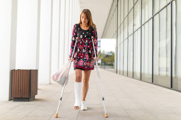 istock Woman with crutches walking down the outside corridor 1771079030