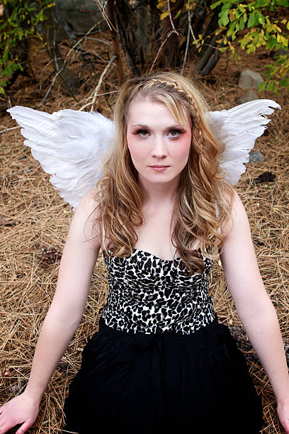 istock Pretty blonde wearing wings sitting. 177108189