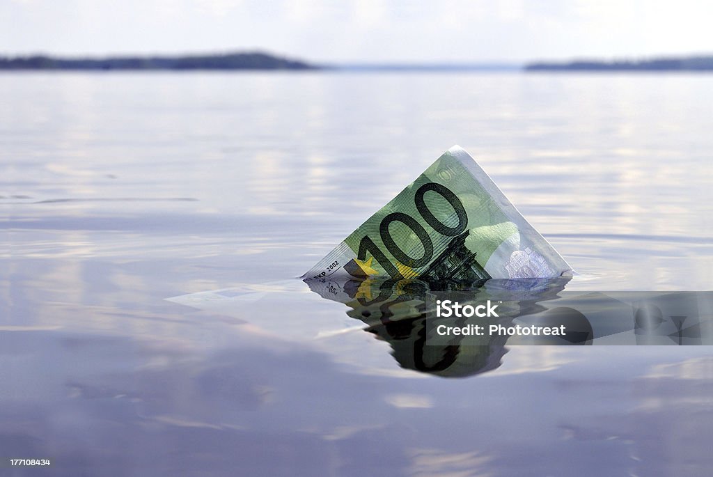 Hundred euros sinking 100-euro note sinking into the water, shot on a lake Sinking Stock Photo