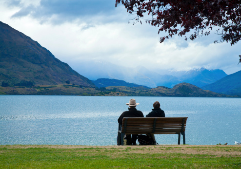 Couple enjoying the view of Lake Wanaka in  New Zealand on an overcast day