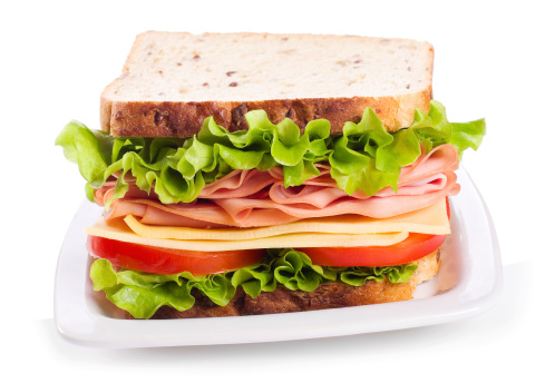 sandwich with bacon and vegetables on white background