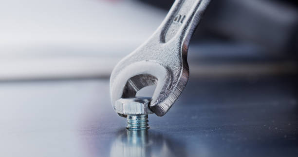 istock Wrench tightens bolt in steel billet. Spanner, bolt, screw and nuts. 1771096387