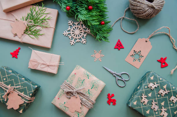 istock Eco friendly Christmas composition with gift boxes in craft reusable paper and natural decor on blue green background top view. Zero waste environmentally friendly Christmas concept. 1771100057