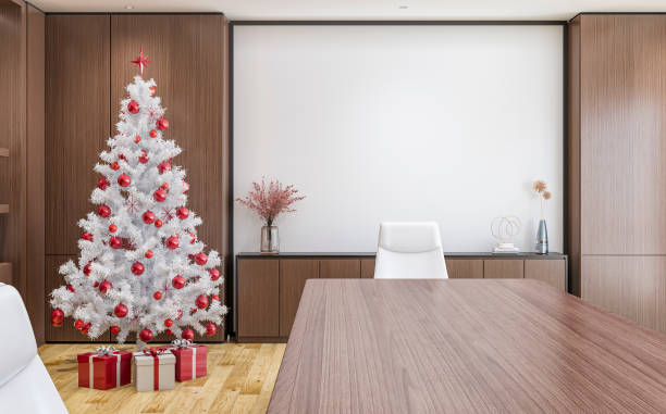 istock A front view of an office interior with a conference table,  leather chairs and a white wide projection screen, with wrapped gifts under a white and red decorated Christmas tree 1771100077