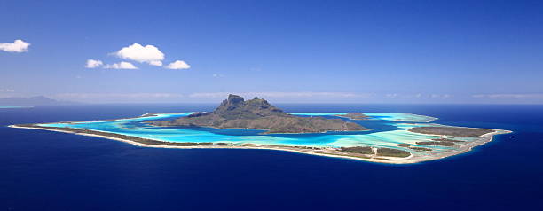 Bora-Bora "Full View of Bora Bora Lagoon, French Polynesia from above on a near cloudless day. Prime honeymoon destination" bora bora mountain stock pictures, royalty-free photos & images