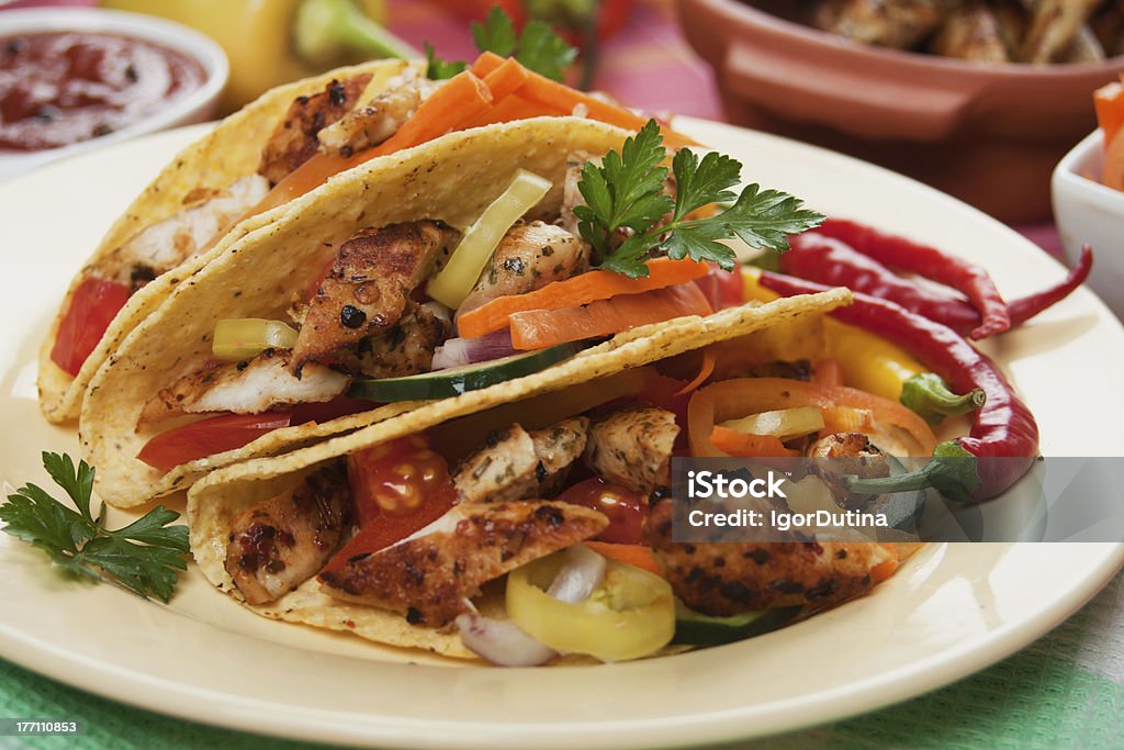 Grilled chicken meat in taco shells "Grilled chicken meat, vegetable and hot chili peppers in taco shells" Chicken Meat Stock Photo