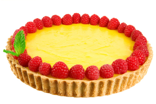 Lemon tart garnished with fresh raspberries and mint isolated on white background