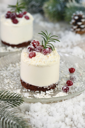 Mousse cakes with coconut cream and Greek yogurt over chocolate cake are the perfect dessert. Add whipped cream and berries. Treat friends and loved ones on Christmas or New Year's Eve