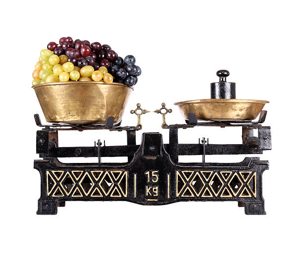 istock Old-fashioned balance scale with grapes isolated on white background 177111263