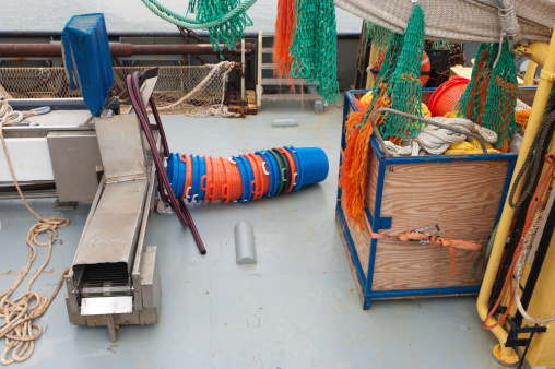 deck of a fishing boat full with fishing equipment