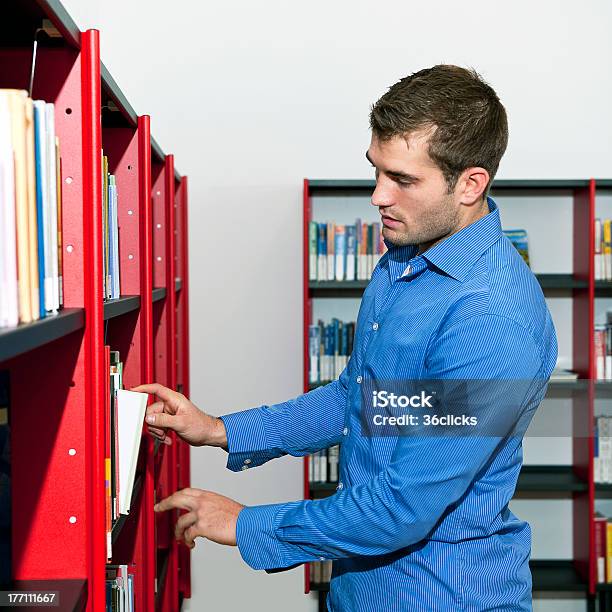 Choosing A Book Stock Photo - Download Image Now - 20-29 Years, Adult, Adults Only