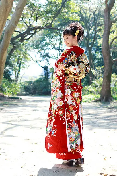 Woman wearing Japanese kimono in the forest.