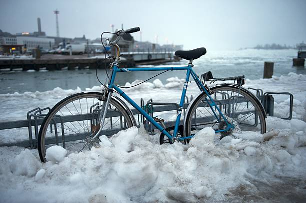 Bicycle parked, partially covered in snow and ice stock photo
