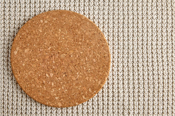 istock Empty round beige cork stand on knitted rough texture. Template for food menu Top view with copy space 1771131264