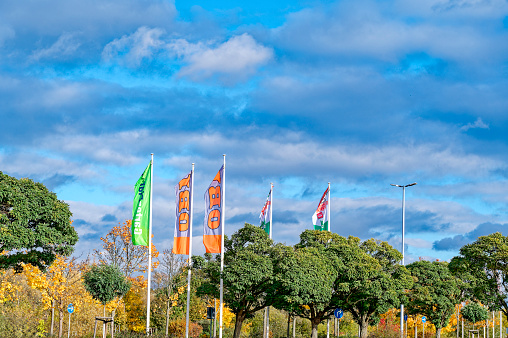 Rangsdorf, Germany - November 01, 2023: Flags of a hardware store in Germany in front of a blue sky.