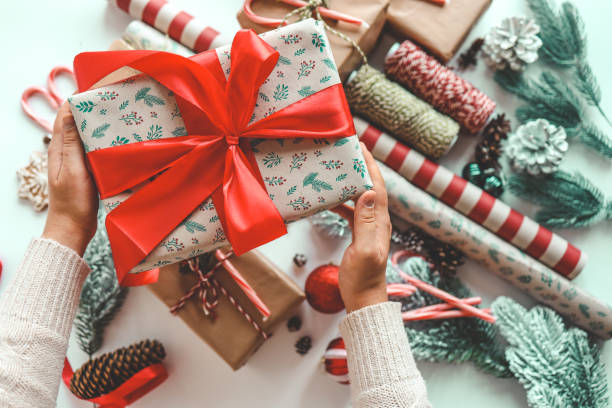 istock Christmas gift with red bow in hands 1771141755