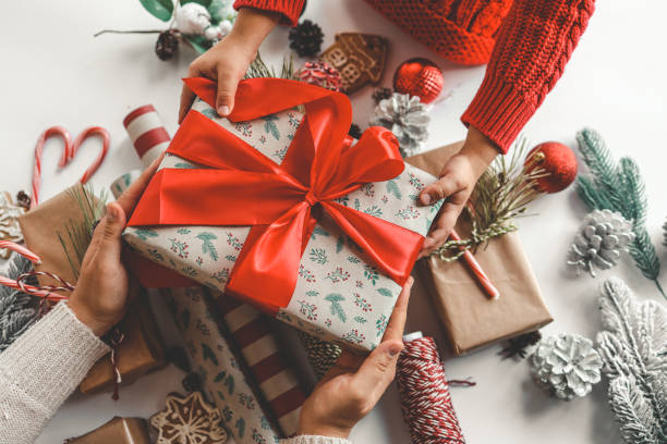 istock Mom and child holding a Christmas gift 1771141757