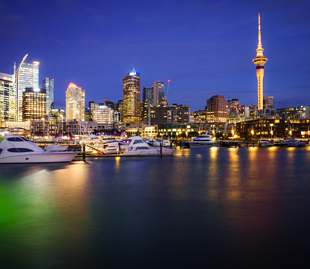 A long exposure night view from the Viaduct Harbour of the downtown skyline of Auckland on New Zealand's North Island.