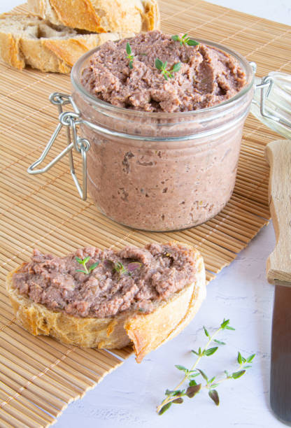 istock Vegan spread made with lentils and nuts on a rustic bread slice and in a glass jar, decorated with rosemary. Vegan dipping. 1771158580