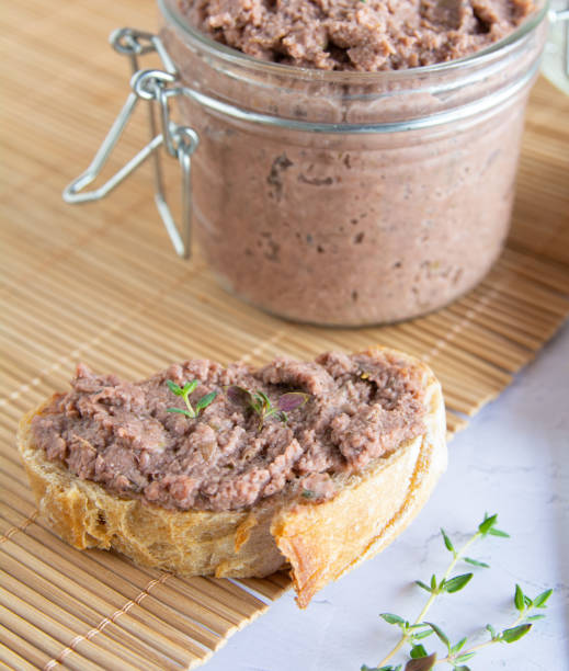 istock Vegan spread made with lentils and nuts on a rustic bread slice and in a glass jar, decorated with rosemary. Vegan dipping. 1771158583