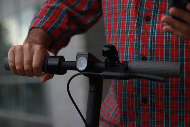 istock Mature man with electric scooter using phone 1771165762