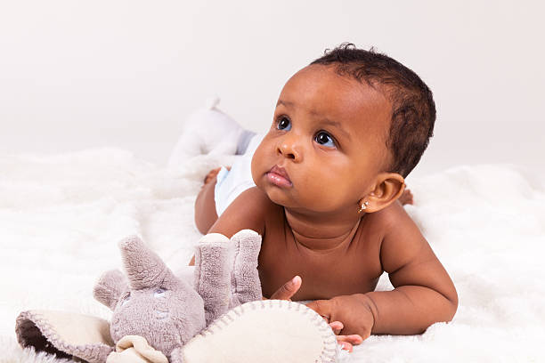 süße african american baby girl lying down - family african ethnicity black african descent stock-fotos und bilder