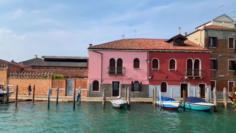 Public transport in the Venice lagoon - Boat tour through the canals and historic monuments of the lagoon city, Gondolas and boats going through the canals of the city of Venice