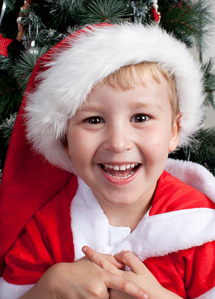 Young caucasian boy dressed in santa hat stock photo