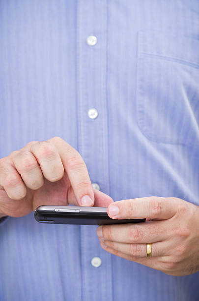 istock Casual businessman operates a touchscreen smartphone 177118731