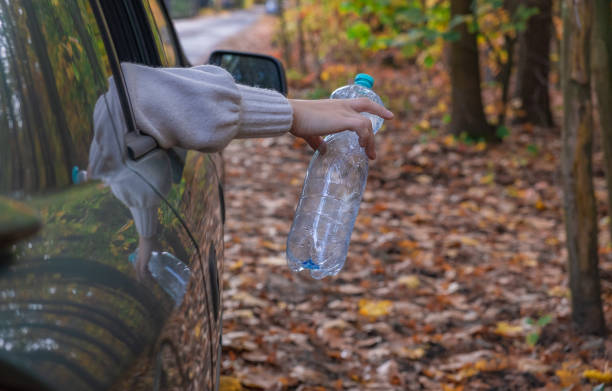 istock A man throws an empty plastic bottle out of a car. We must protect the environment, we have one planet 1771192898