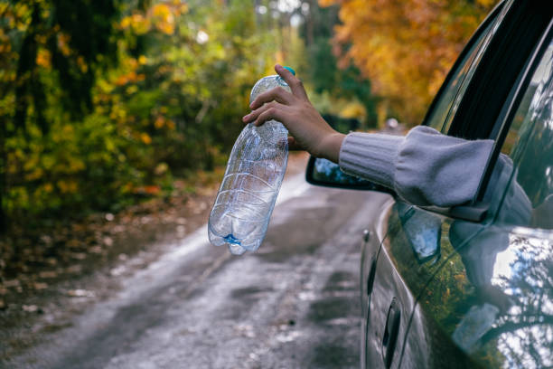 istock A man throws an empty plastic bottle out of a car. We must protect the environment, we have one planet 1771192899