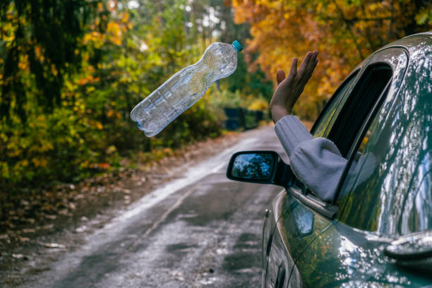 istock A man throws an empty plastic bottle out of a car. We must protect the environment, we have one planet 1771193406
