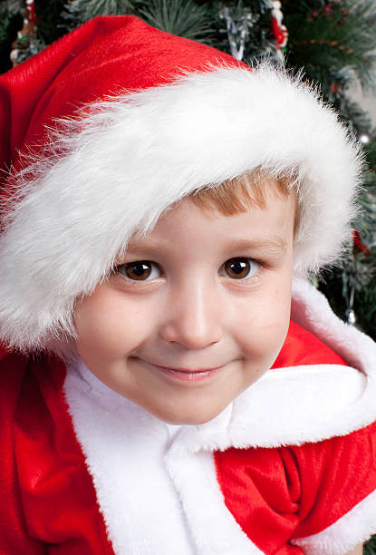 Young caucasian boy dressed in santa hat stock photo