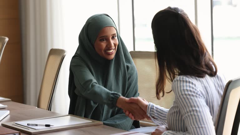 Young Somalian businesswoman shake hands colleague after meeting