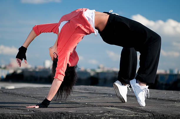 istock woman dancing hip hop over blue sky 177119961