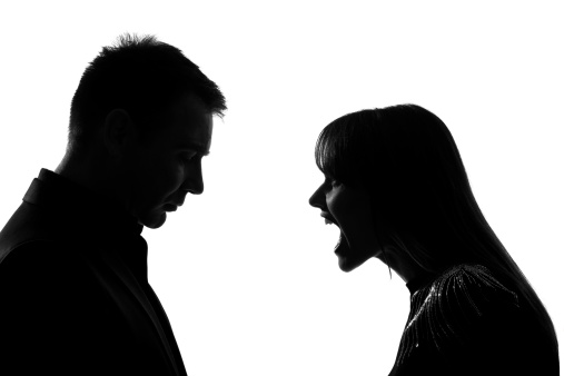 one caucasian couple man and woman face to face screaming shouting dipute in studio silhouette   on white background