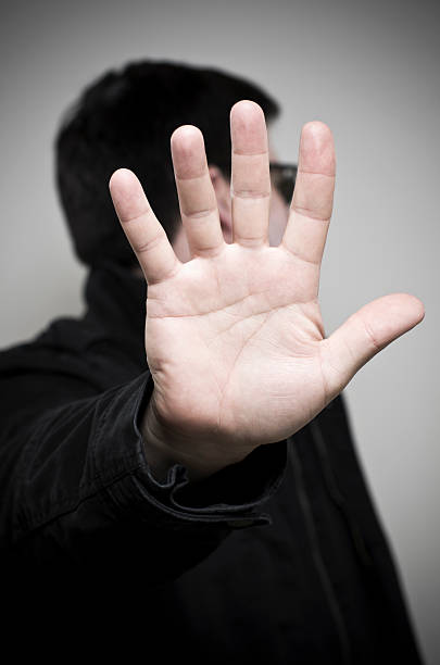 istock Mystery man holding up hand and looking away 177121913