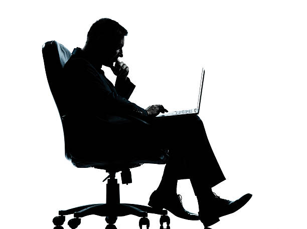 istock one business man computer computing sitting in armchair silhouet 177122042
